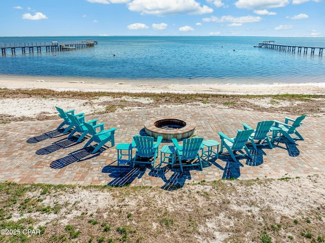 property view of water with a beach view and an outdoor fire pit