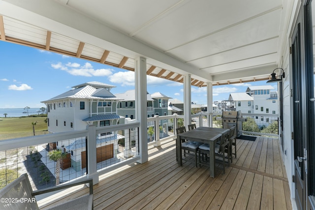 deck featuring grilling area, a residential view, and a water view