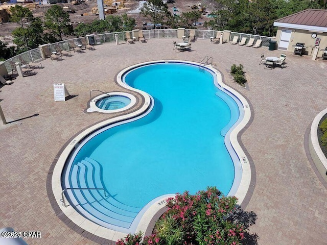 11800 Front Bch Unit 2-407, Panama City Beach, FL 32407 - community pool with fence, a community hot tub, and a patio