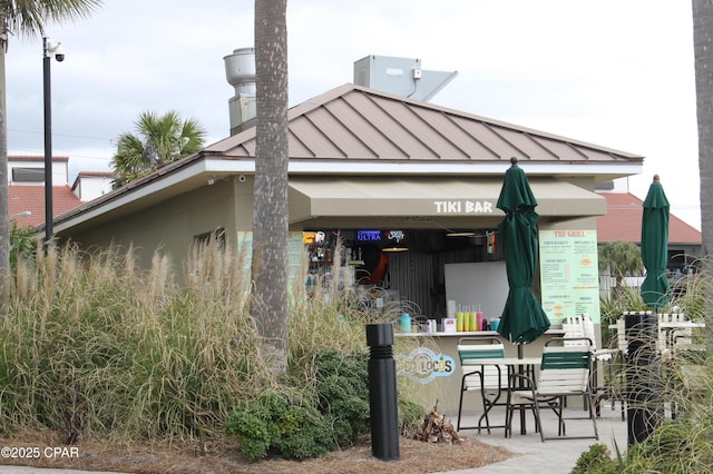 11800 Front Bch Unit 2-407, Panama City Beach, FL 32407 - exterior space with metal roof, a standing seam roof, and a chimney