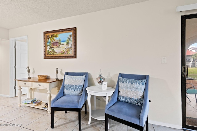 520 N Richard Jackson Blvd Unit 1804, Panama City Beach, FL 32407 - living area with light tile patterned floors, a textured ceiling, and baseboards