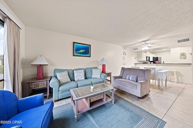 520 N Richard Jackson Blvd Unit 1804, Panama City Beach, FL 32407 - living room featuring ceiling fan, light tile patterned floors, and a textured ceiling