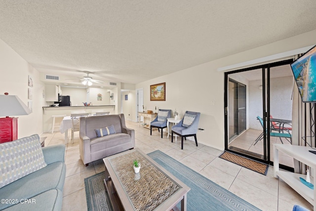 520 N Richard Jackson Blvd Unit 1804, Panama City Beach, FL 32407 - living room featuring light tile patterned floors, a ceiling fan, and a textured ceiling