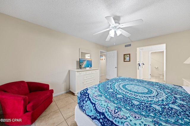 520 N Richard Jackson Blvd Unit 1804, Panama City Beach, FL 32407 - bedroom featuring light tile patterned floors, a textured ceiling, ceiling fan, baseboards, and ensuite bathroom