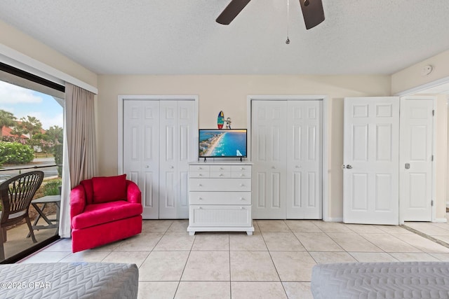 520 N Richard Jackson Blvd Unit 1804, Panama City Beach, FL 32407 - bedroom featuring access to outside, multiple closets, light tile patterned floors, a textured ceiling, and a ceiling fan