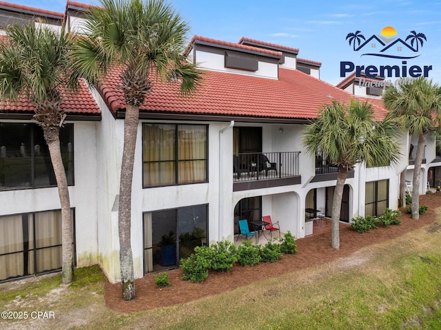 520 N Richard Jackson Blvd Unit 1804, Panama City Beach, FL 32407 - back of house featuring a tile roof, a balcony, and stucco siding