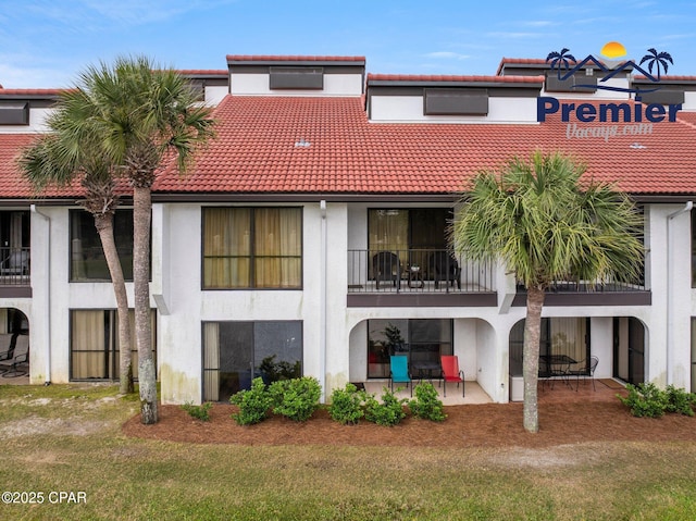 520 N Richard Jackson Blvd Unit 1804, Panama City Beach, FL 32407 - rear view of house with a balcony, stucco siding, and a tiled roof