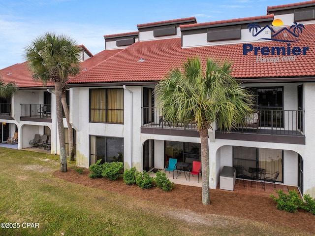 520 N Richard Jackson Blvd Unit 1804, Panama City Beach, FL 32407 - back of house featuring a balcony, stucco siding, a patio, and a tile roof