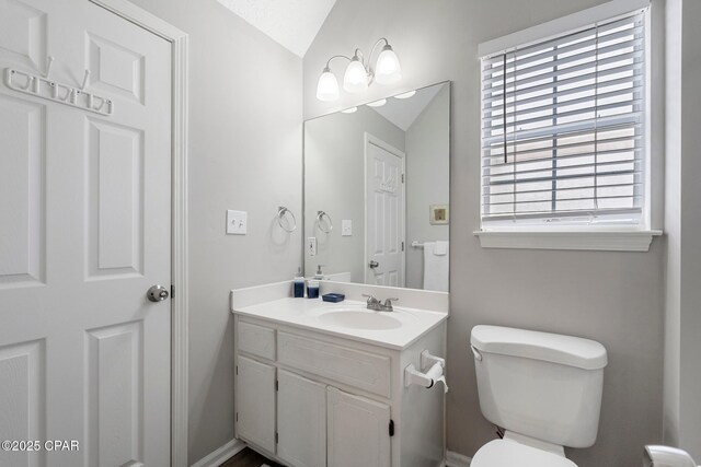 17878 Front Beach Rd Unit B2, Panama City Beach, FL 32413 - bathroom with toilet, vanity, and vaulted ceiling