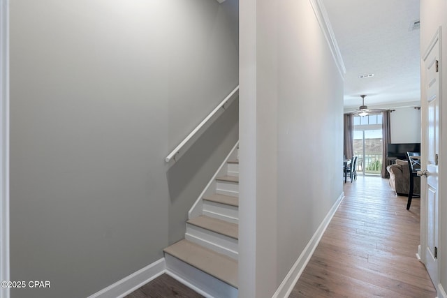 17878 Front Beach Rd Unit B2, Panama City Beach, FL 32413 - staircase with visible vents, baseboards, ornamental molding, wood finished floors, and ceiling fan