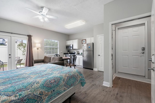 17878 Front Beach Rd Unit B2, Panama City Beach, FL 32413 - bedroom featuring french doors, access to outside, a textured ceiling, dark wood-style floors, and freestanding refrigerator