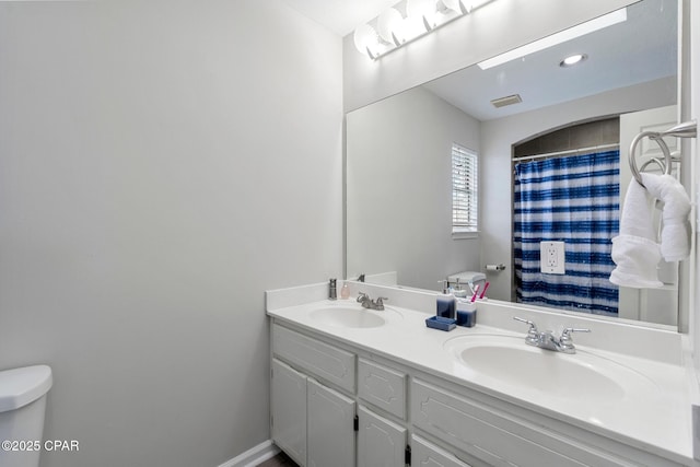 17878 Front Beach Rd Unit B2, Panama City Beach, FL 32413 - full bathroom with double vanity, visible vents, toilet, and a sink