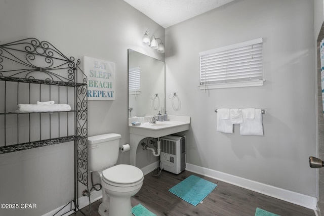 17878 Front Beach Rd Unit B2, Panama City Beach, FL 32413 - bathroom featuring toilet, baseboards, and wood finished floors