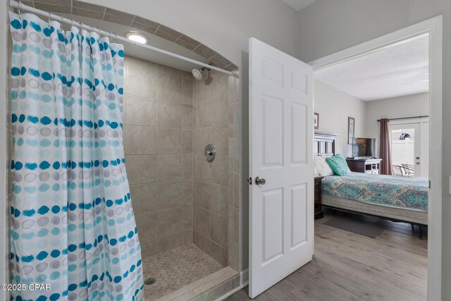 17878 Front Beach Rd Unit B2, Panama City Beach, FL 32413 - ensuite bathroom with ensuite bathroom, tiled shower, and wood finished floors