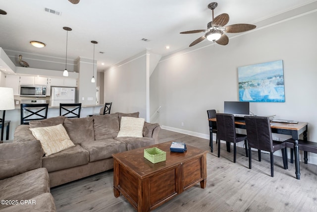 17878 Front Beach Rd Unit B2, Panama City Beach, FL 32413 - living area with visible vents, crown molding, light wood finished floors, baseboards, and ceiling fan