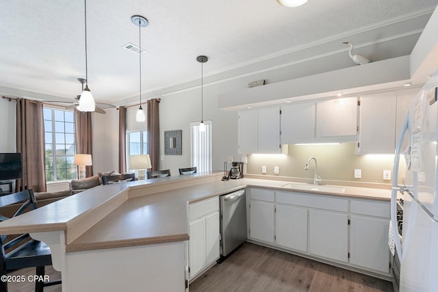 17878 Front Beach Rd Unit B2, Panama City Beach, FL 32413 - kitchen with light wood-type flooring, stainless steel dishwasher, a sink, visible vents, and a peninsula