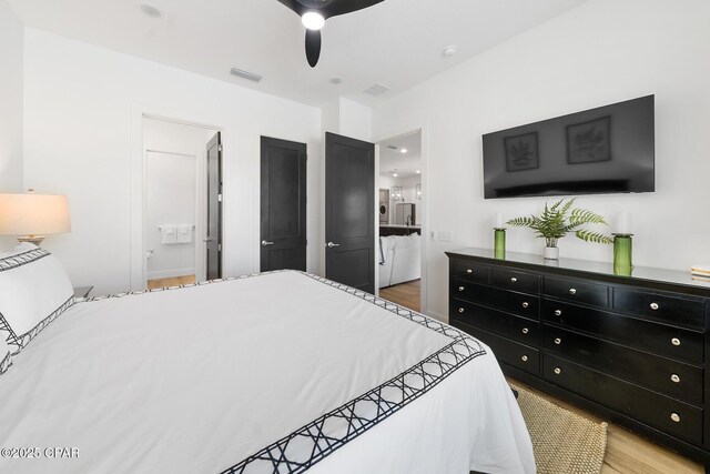 314 Tanaga St, Panama City Beach, FL 32413 - bedroom with ensuite bathroom, wood finished floors, and a ceiling fan