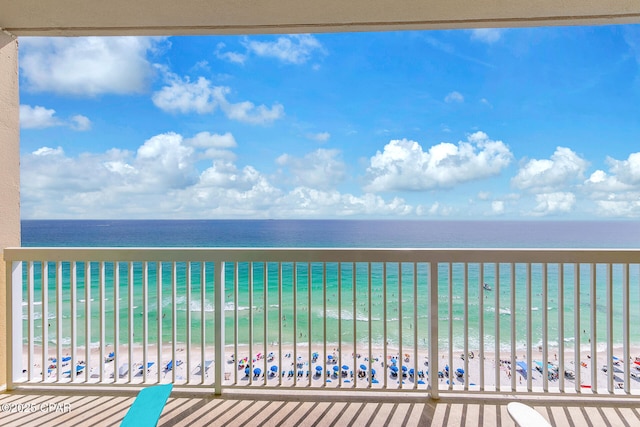 balcony featuring a beach view and a water view