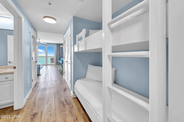 hall with baseboards and light wood-type flooring