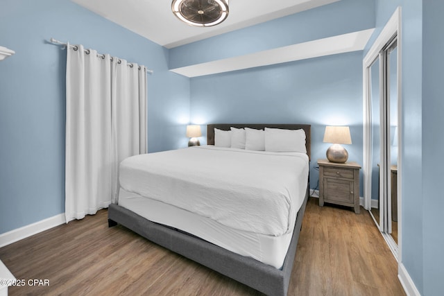 bedroom featuring baseboards and wood finished floors