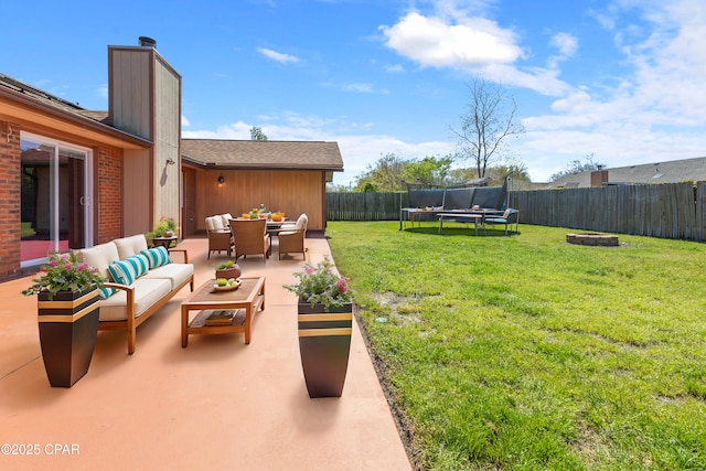 1606 Belmont Blvd, Lynn Haven, FL 32444 - fenced backyard with an outdoor living space with a fire pit, a trampoline, and a patio