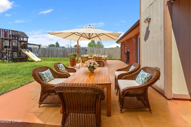1606 Belmont Blvd, Lynn Haven, FL 32444 - fenced backyard with a playground, outdoor dining area, and a patio area