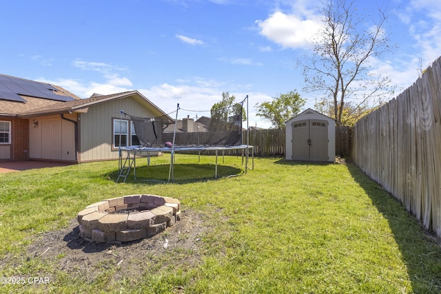 1606 Belmont Blvd, Lynn Haven, FL 32444 - fenced backyard with a trampoline, a storage shed, a fire pit, and a patio area