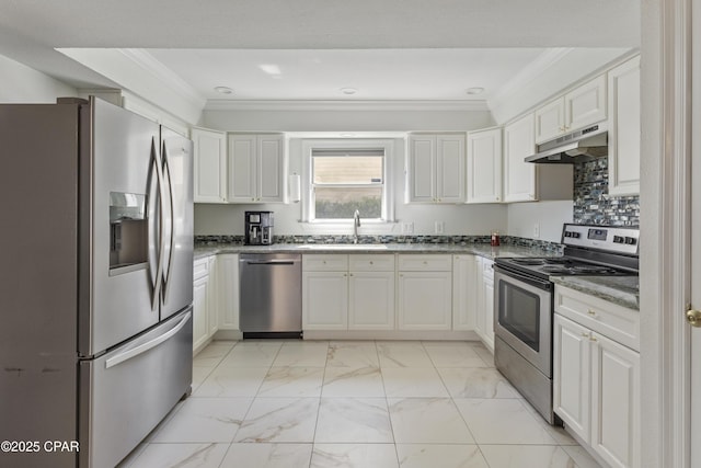 1606 Belmont Blvd, Lynn Haven, FL 32444 - kitchen featuring stainless steel appliances, under cabinet range hood, ornamental molding, light marble finish floors, and white cabinetry