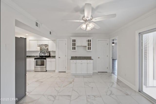 1606 Belmont Blvd, Lynn Haven, FL 32444 - kitchen featuring appliances with stainless steel finishes, under cabinet range hood, dark countertops, a ceiling fan, and glass insert cabinets