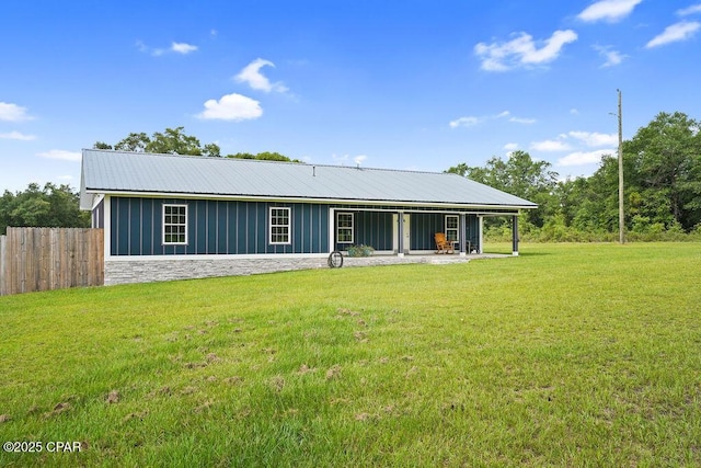 2089 Pike Pond Rd, Alford, FL 32420 - back of house with a metal roof, board and batten siding, and stone siding