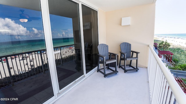 balcony with view of water and beach