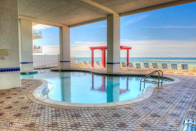 community pool featuring a jacuzzi and a water view