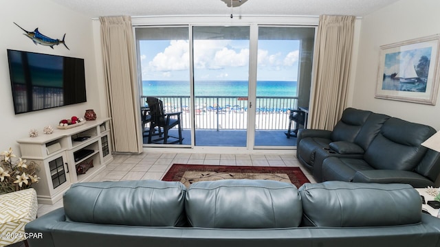 tiled living area with healthy amount of natural light and a water view