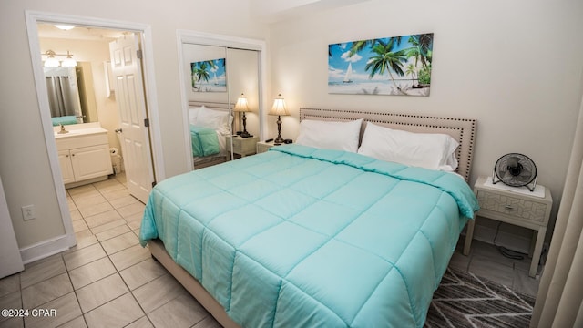 bedroom featuring light tile patterned floors, a closet, and connected bathroom