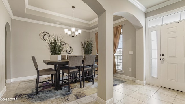 221 S Shoreview Dr, Panama City, FL 32404 - dining space with arched walkways, a chandelier, tile patterned floors, baseboards, and ornamental molding