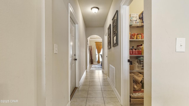 221 S Shoreview Dr, Panama City, FL 32404 - hallway featuring arched walkways, light tile patterned floors, and baseboards