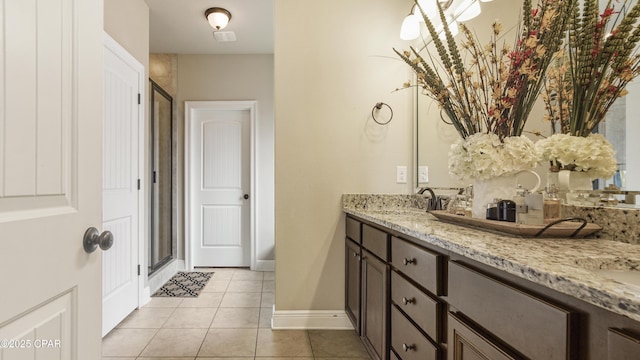 221 S Shoreview Dr, Panama City, FL 32404 - bathroom featuring double vanity, a stall shower, tile patterned floors, and baseboards