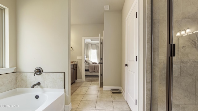 221 S Shoreview Dr, Panama City, FL 32404 - full bath with a garden tub, tile patterned flooring, ensuite bathroom, tiled shower, and baseboards
