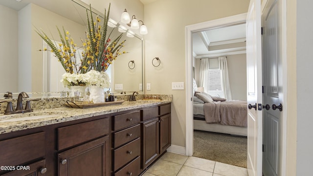 221 S Shoreview Dr, Panama City, FL 32404 - ensuite bathroom featuring double vanity, tile patterned flooring, baseboards, and a raised ceiling