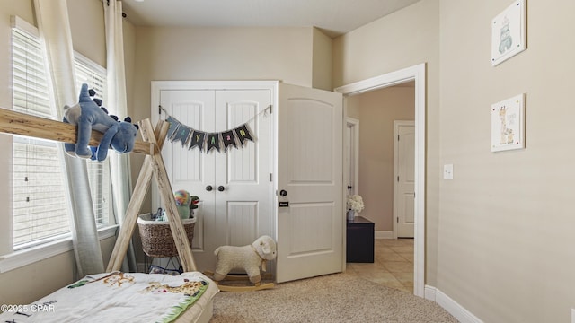 221 S Shoreview Dr, Panama City, FL 32404 - bedroom with multiple windows, light carpet, light tile patterned flooring, and a closet