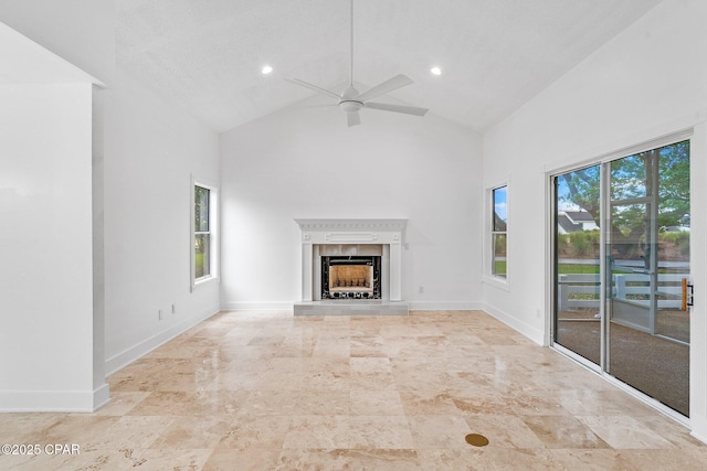 unfurnished living room with a fireplace with raised hearth, recessed lighting, high vaulted ceiling, and ceiling fan