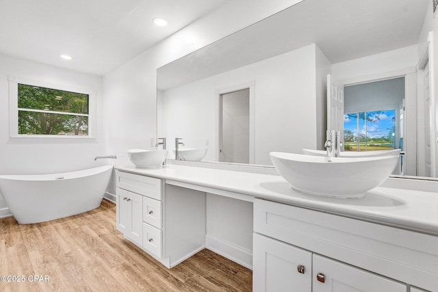 bathroom featuring a wealth of natural light, double vanity, and a sink