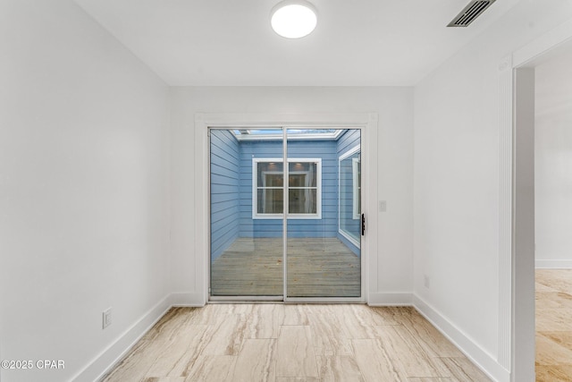 empty room with baseboards and visible vents