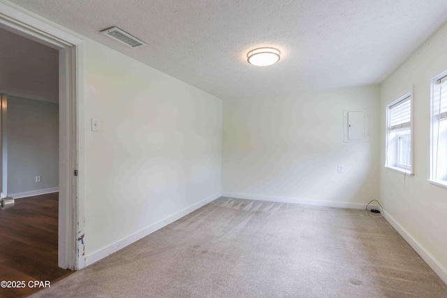 911 Indiana Ave, Lynn Haven, FL 32444 - carpeted empty room featuring a textured ceiling and electric panel