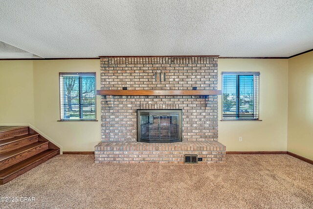 carpeted living room with stairway, a brick fireplace, baseboards, visible vents, and ornamental molding