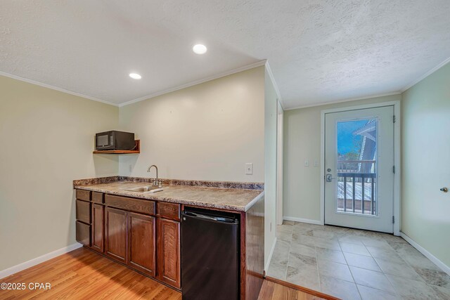 kitchen featuring a sink, crown molding, black appliances, and a textured ceiling