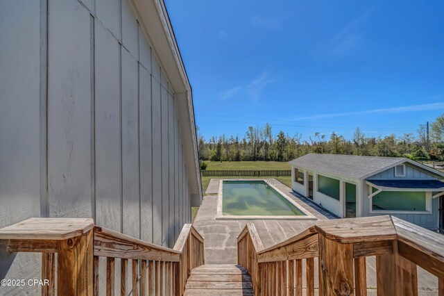 exterior space with a fenced in pool and fence
