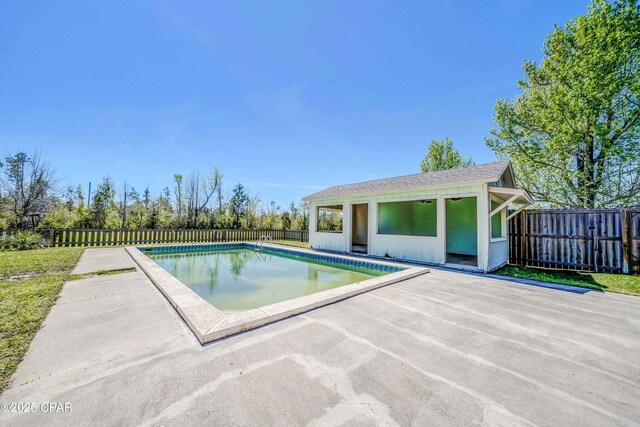 view of pool featuring a fenced backyard, a fenced in pool, an outbuilding, and a patio