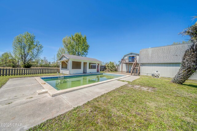 view of pool with stairs, a fenced in pool, fence, an outdoor structure, and a lawn