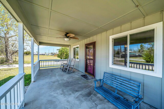 view of patio with ceiling fan and a porch